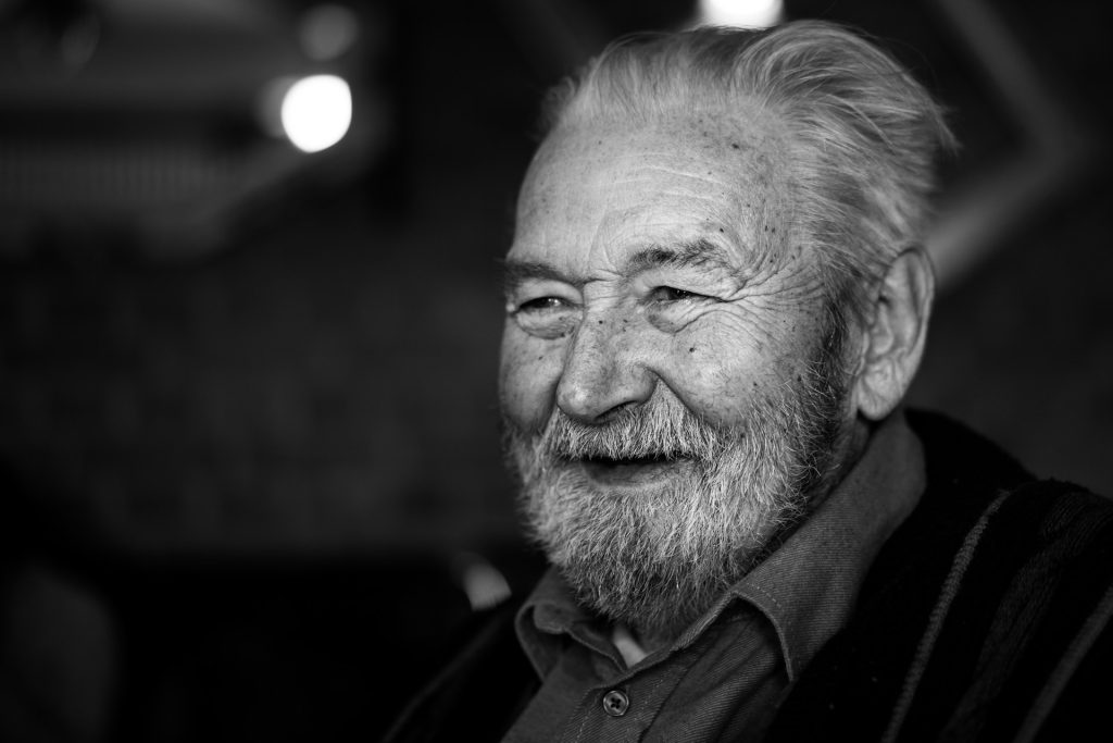 A grayscale photo of an old man