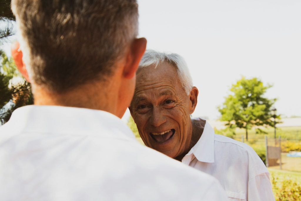 Old man in white smiling