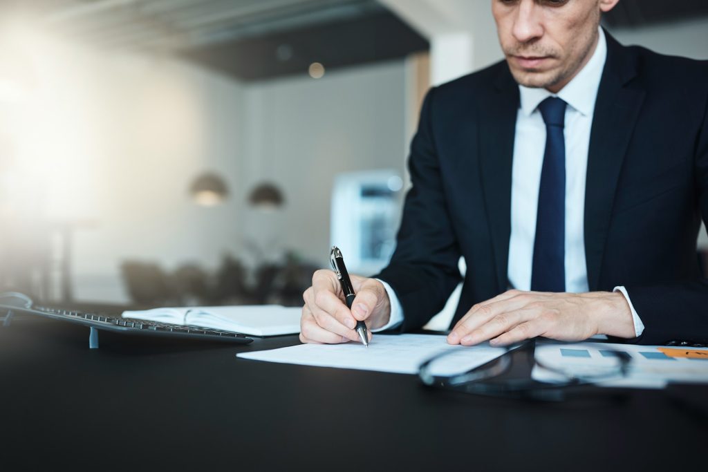 A person writing on a paper