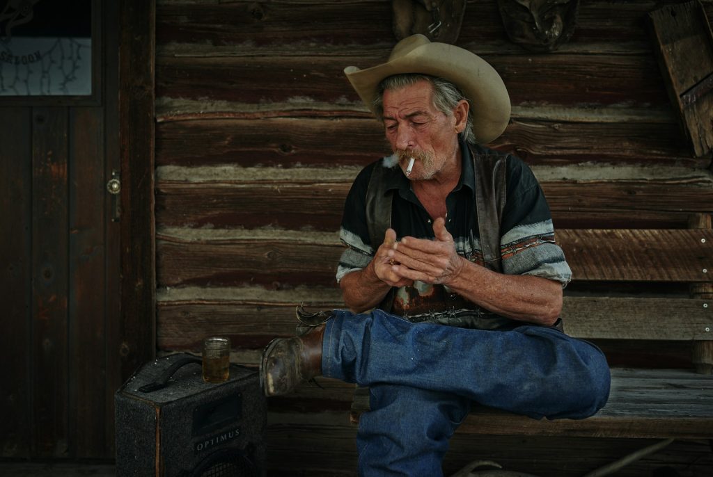 Man sitting on brown wooden chair