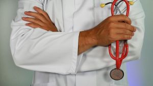 Doctor holding red stethoscope