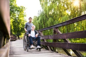 Young person walking an old person