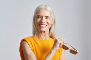 An old woman wearing a yellow top