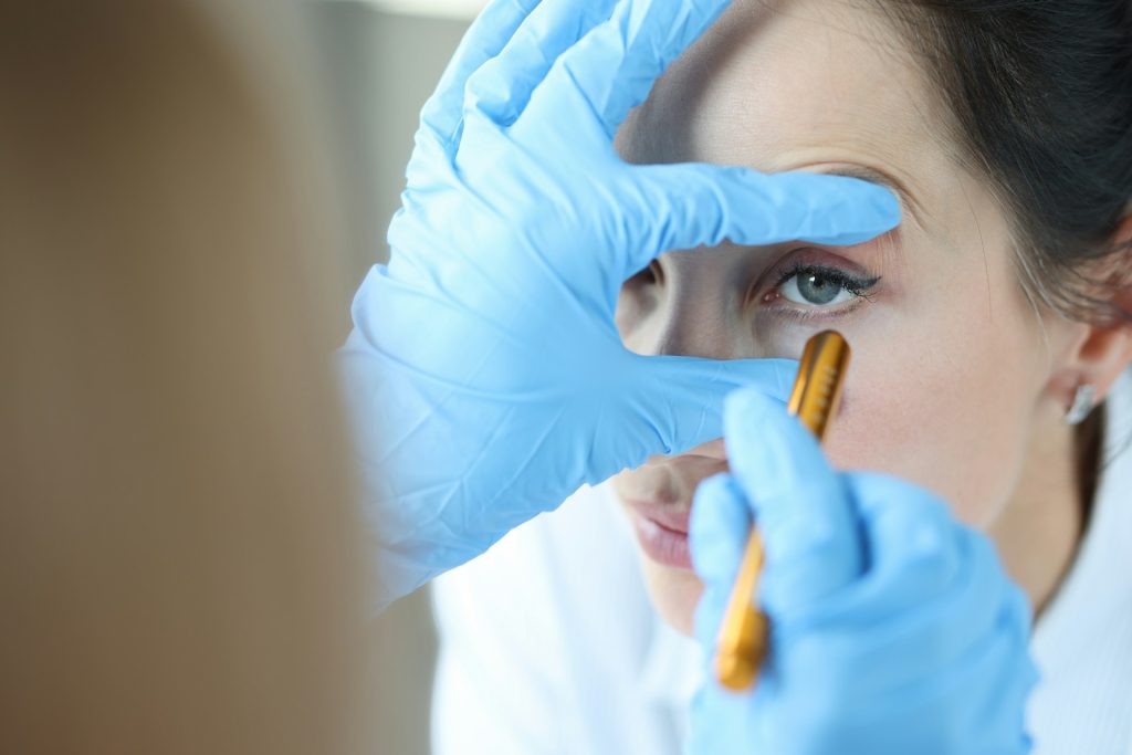 Doctor shines light into patient