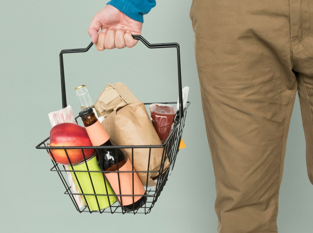 A person holding a grocery