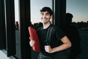 A man holding a red bag