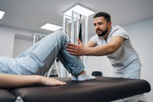 A man holding another persons knee