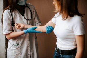 A woman holding the arm of another person