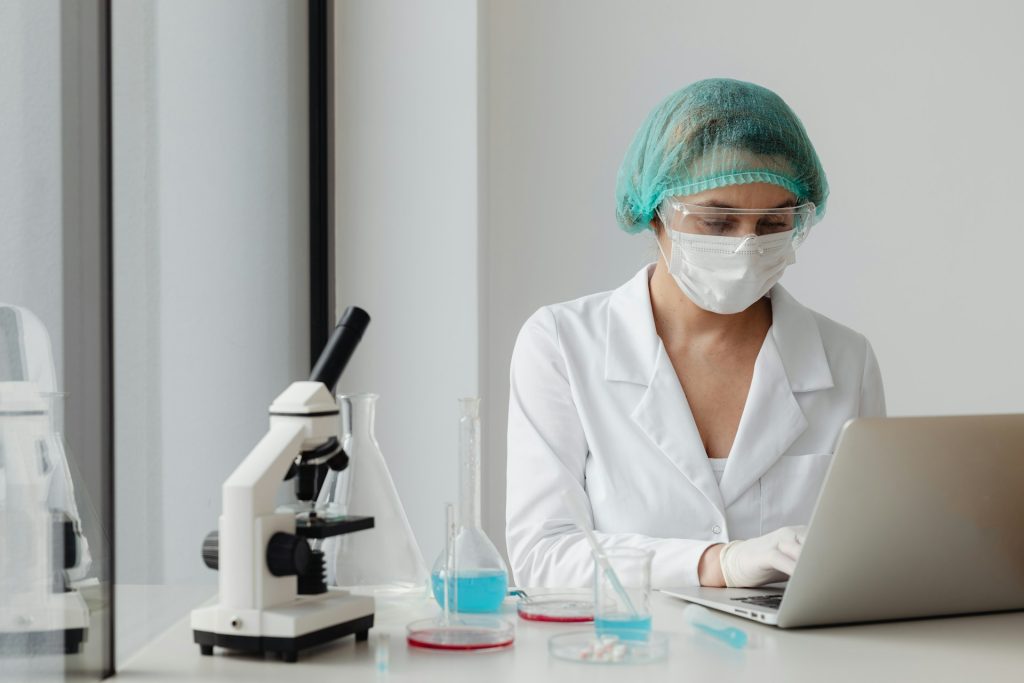 A photo of a woman in a white lab coat