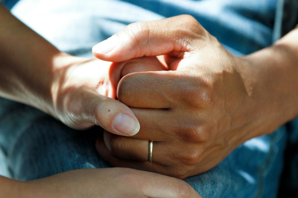 A hand holding another hand