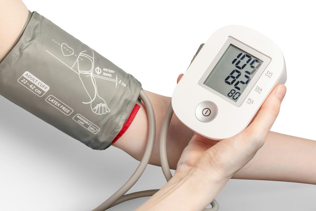 A person holding a blood pressure monitor