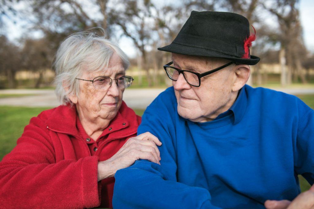 Old couple sitting at a park